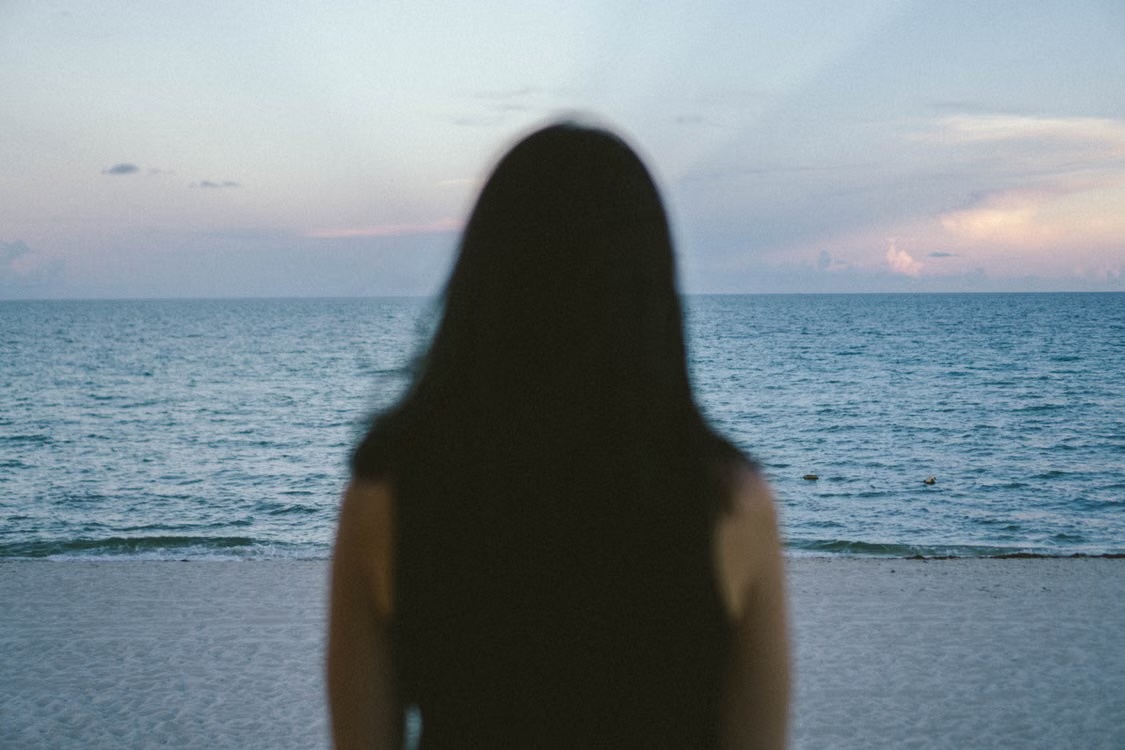 The teacher, facing away